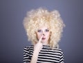 Portrait of funny girl in blonde wig. Royalty Free Stock Photo