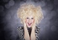 Portrait of funny girl in blonde wig Royalty Free Stock Photo