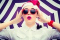 Portrait of a funny girl in Santa Claus hat and red sunglasses Royalty Free Stock Photo