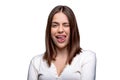 Portrait of funny girl with showing tongue winking with one eye, making faces, fooling around. Funky flirty young woman Royalty Free Stock Photo