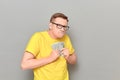 Portrait of funny greedy man holding money in hands