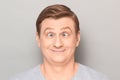 Portrait of funny happy man making goofy face with crossed eyes Royalty Free Stock Photo