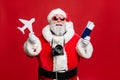 Portrait of funny hipster santa claus have journey abroad in terminal want travel take photo photigraphing wear Royalty Free Stock Photo