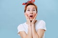 Portrait of a funny housewife with short ginger hair making surprise gesture Royalty Free Stock Photo