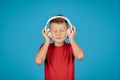 Portrait Of Funny Little Boy Listening Music In Wireless Headphones Royalty Free Stock Photo