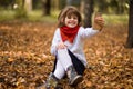 Portrait of funny little girl grimacing while taking selfie over autumn Royalty Free Stock Photo