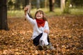 Portrait of funny little girl grimacing while taking selfie over autumn Royalty Free Stock Photo