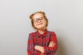 Portrait of a funny little preschool child girl in glasses on gray background. Concept education. Back to school Royalty Free Stock Photo