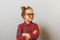 Portrait of a funny little preschool child girl in glasses on gray background. Education. Back to school Royalty Free Stock Photo