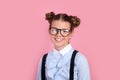 Portrait of a funny little school child girl in glasses on pink background. Education . Back to school Royalty Free Stock Photo