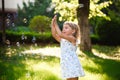 Portrait of funny lovely little girl blowing soap bubbles Royalty Free Stock Photo