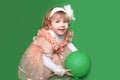 Portrait of funny lovely little girl playing with balloon over g Royalty Free Stock Photo