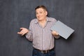 Portrait of funny man holding folder and shrugging shoulders Royalty Free Stock Photo