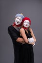 Portrait of funny mime couple with white faces and