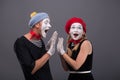 Portrait of funny mime couple with white faces and