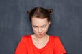 Portrait of funny obstinate girl looking with displeasure at camera Royalty Free Stock Photo
