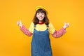 Portrait of funny pretty girl teenager in french beret, denim sundress showing thumbs up isolated on yellow wall Royalty Free Stock Photo