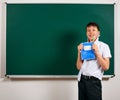 Portrait of funny pupil. School boy very emotional, having fun and very happy, blackboard background - back to school and