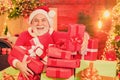 Portrait of funny Santa man indoors with Christmas gift. Bearded man having fun near Christmas tree indoors.