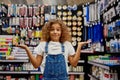 Portrait of funny school girl feeling confused standing at stationery store