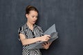 Portrait of funny shocked office girl looking at papers