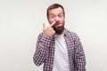 Portrait of funny silly bearded man showing tongue with comical silly face, adult with bad manners. white background