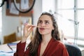 Portrait of funny woman with pencil in mouth, having fun at work. Royalty Free Stock Photo