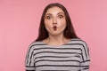 Portrait of funny wondered woman in striped sweatshirt making fish face grimace with lips and looking amazed Royalty Free Stock Photo