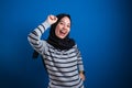 Portrait of a funny young Asian muslim girl wearing hijab dancing happily joyful expressing celebrating good news Royalty Free Stock Photo