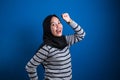 Portrait of a funny young Asian muslim girl wearing hijab dancing happily joyful expressing celebrating good news Royalty Free Stock Photo