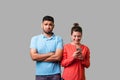 Portrait of funny young man looking resentful, upset about woman addicted to phone. isolated on gray background, indoor studio Royalty Free Stock Photo