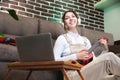 portrait of a funny young woman playing the ukulele. The girl sits, sings and plays the ukulele. Women are happy in Royalty Free Stock Photo