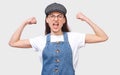 Portrait of furios young woman raises hands clenched in fists, screams with anger, isolated over white background, wears round