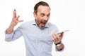 Portrait of a furious mature man dressed in shirt yelling