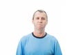 Portrait of furious middle age man looking strained, isolated on white background. Angry casual mature man reacting annoyed,