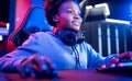 Portrait Gamer African American beautiful woman play online games computer, streamer neon room