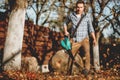 Gardener using a garden blower, clearing up leaves