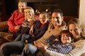 Portrait 3 generation family at home by firelight Royalty Free Stock Photo