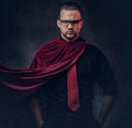 Portrait of a genius villain superhero in a black shirt with a red tie. Royalty Free Stock Photo