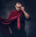 Portrait of a genius villain superhero in a black shirt with a red tie. Royalty Free Stock Photo