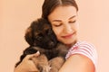 Portrait of German shepherd puppy posing on woman`s hands