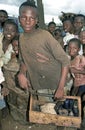 Portrait Ghanaian shoeshine boy with shoe polish