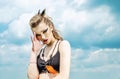 Portrait of a girl with aggressive make-up war paint indian amazon posing against the sky on nature Royalty Free Stock Photo