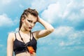 Portrait of a girl with aggressive make-up war paint indian amazon posing against the sky on nature Royalty Free Stock Photo