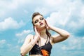 Portrait of a girl with aggressive make-up war paint indian amazon posing against the sky on nature Royalty Free Stock Photo