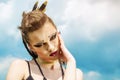 Portrait of a girl with aggressive make-up war paint indian amazon posing against the sky on nature Royalty Free Stock Photo