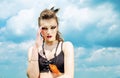 Portrait of a girl with aggressive make-up war paint indian amazon posing against the sky on nature Royalty Free Stock Photo