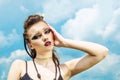 Portrait of a girl with aggressive make-up war paint indian amazon posing against the sky on nature Royalty Free Stock Photo