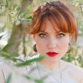 Portrait of a girl on the background of the olive tree