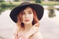 Portrait of a girl on the background of the river. Beautiful girl in the beach with pink hair and beautiful makeup. Royalty Free Stock Photo